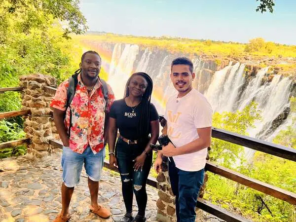 Saif with two friends at a waterfall viewpoint